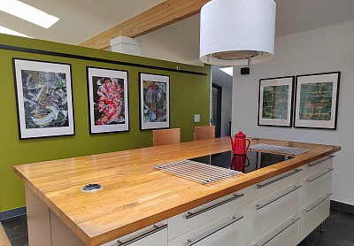 Five abstract painting by Peter Jackson displayed in a kitchen