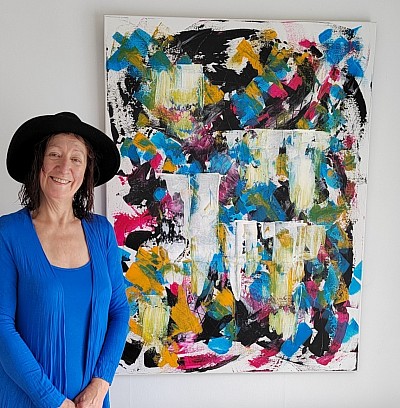 Client standing next to her new painting