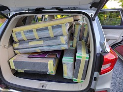 Car full of bubble wrapped paintings